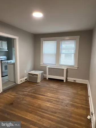a view of a room with wooden floor and window