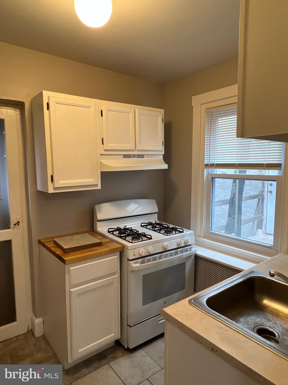 243 Haverford Avenue, Unit 2 Narberth, PA 19072 - Photo 9 of 10 a kitchen with white cabinets and white appliances