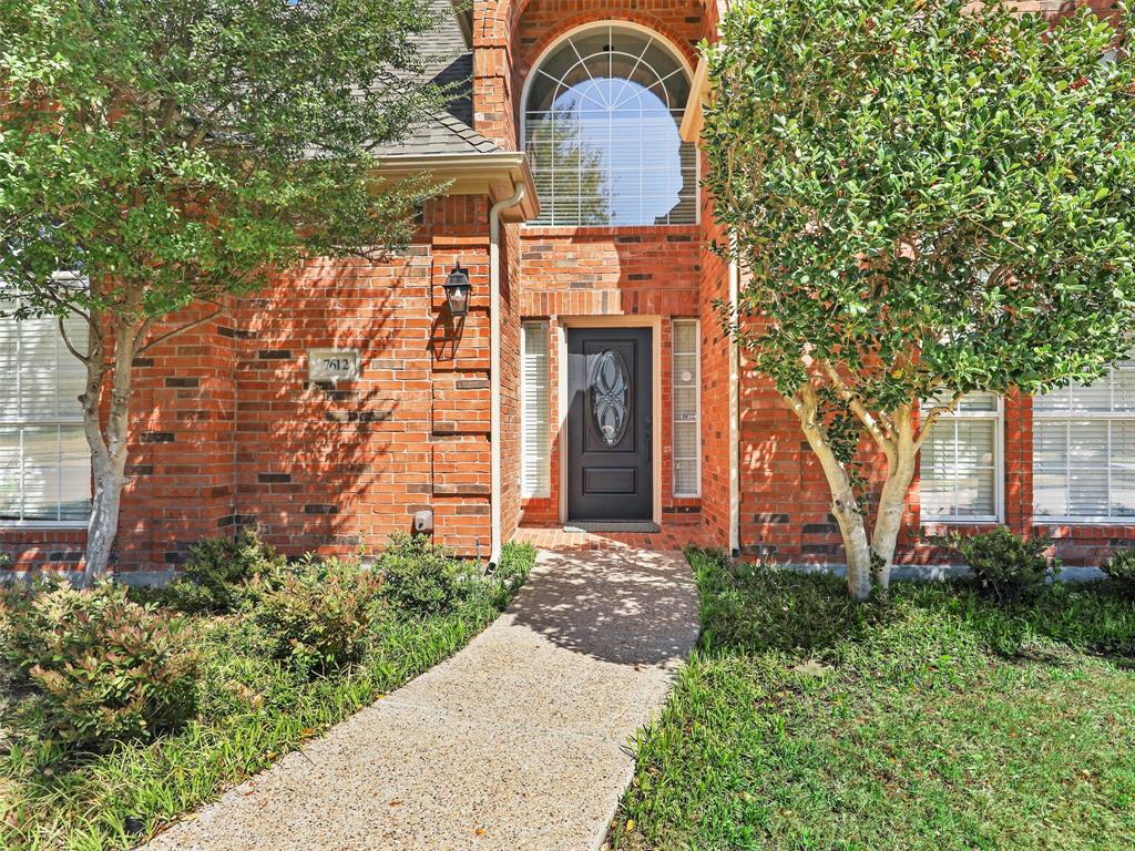 7612 Pendleton Street Dallas, TX 75252 - Photo 12 of 38 a front view of a house with garden