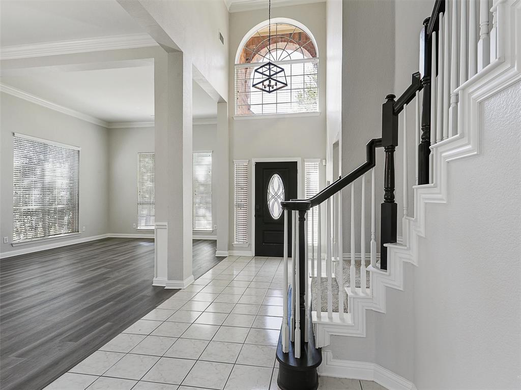 7612 Pendleton Street Dallas, TX 75252 - Photo 14 of 38 a view of entryway with stairs and wooden floor