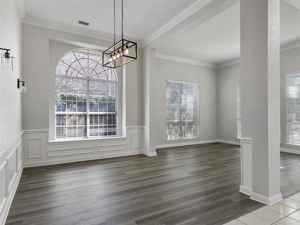 7612 Pendleton Street Dallas, TX 75252 - Photo 15 of 38 a view of an empty room with wooden floor and a window