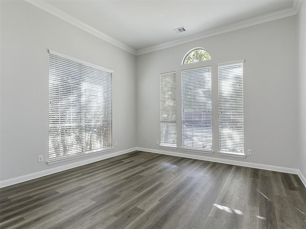 7612 Pendleton Street Dallas, TX 75252 - Photo 16 of 38 a view of an empty room with a window and wooden floor