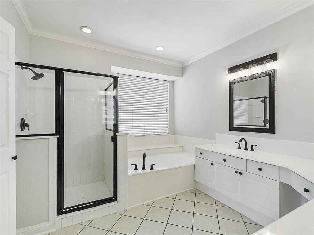 7612 Pendleton Street Dallas, TX 75252 - Photo 22 of 38 a bathroom with a double vanity sink mirror and a bathtub