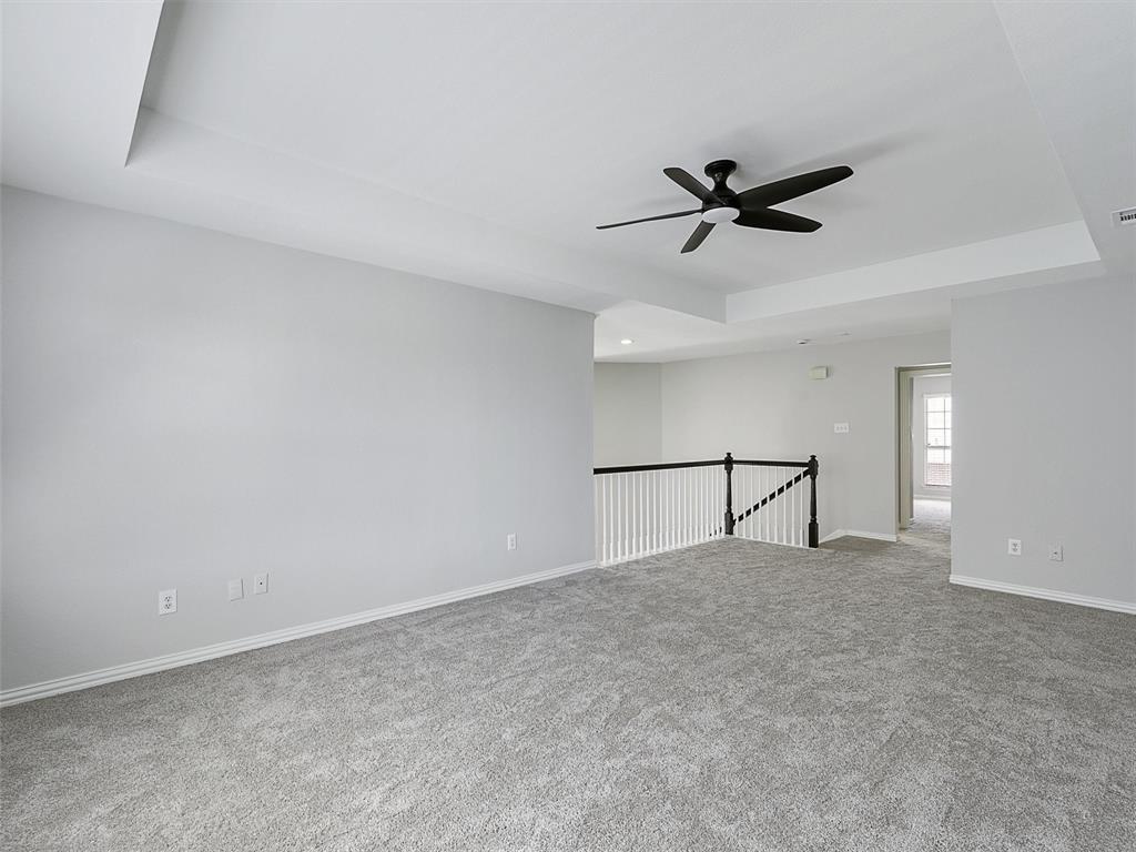 7612 Pendleton Street Dallas, TX 75252 - Photo 26 of 38 a view of an empty room and a ceiling fan