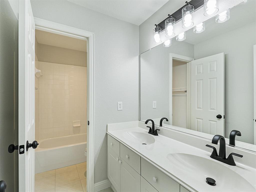 7612 Pendleton Street Dallas, TX 75252 - Photo 27 of 38 a bathroom with a sink and a mirror