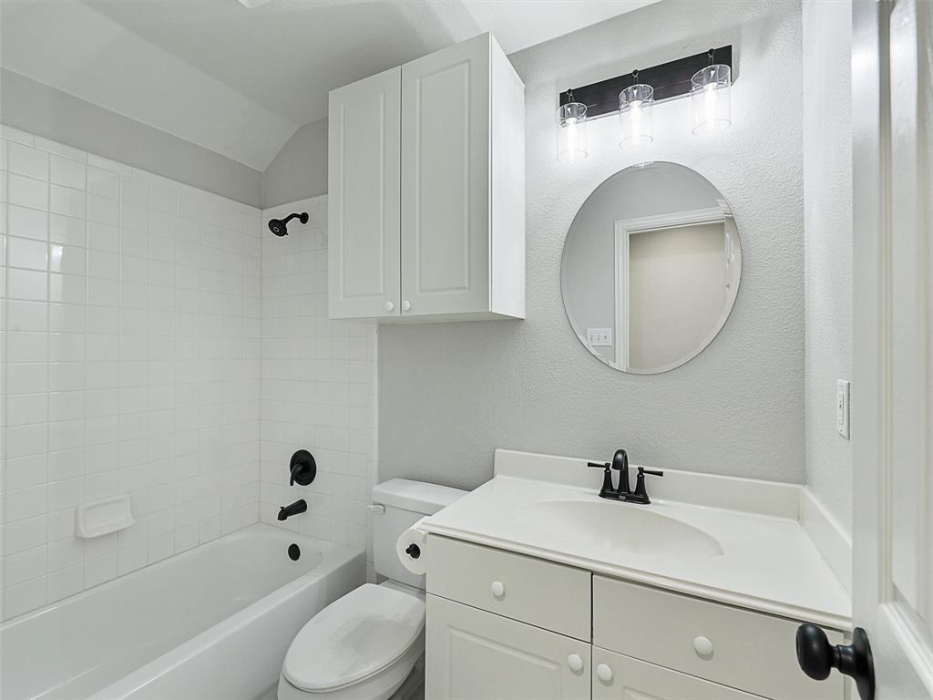 7612 Pendleton Street Dallas, TX 75252 - Photo 29 of 38 a bathroom with a sink a toilet and a mirror