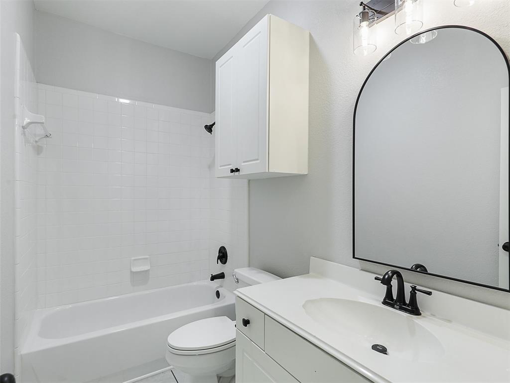 7612 Pendleton Street Dallas, TX 75252 - Photo 30 of 38 a bathroom with a sink a toilet and a bathtub