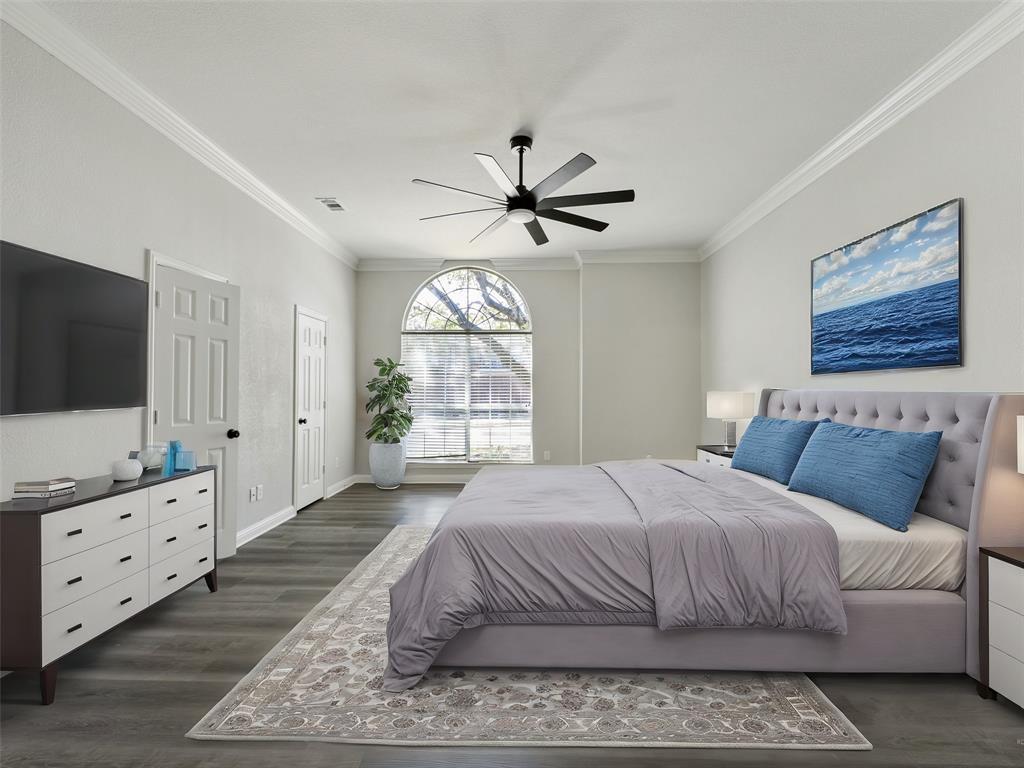 7612 Pendleton Street Dallas, TX 75252 - Photo 6 of 38 a bedroom with a large bed and a flat screen tv