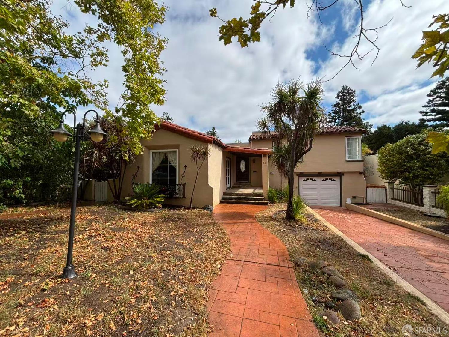 450 Laurel Avenue Millbrae, CA 94030 - Photo 1 of 27 a front view of a house with a yard and garage