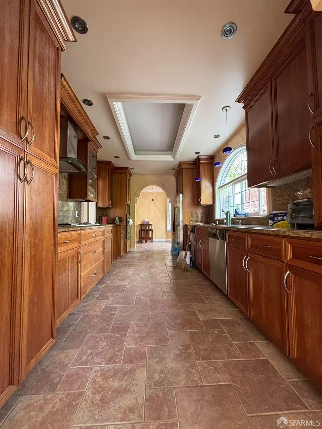 450 Laurel Avenue Millbrae, CA 94030 - Photo 21 of 27 a kitchen with stainless steel appliances granite countertop a sink refrigerator and cabinets