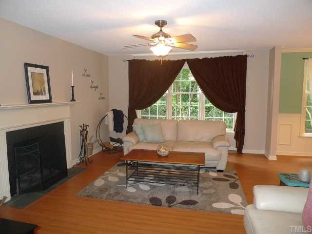 2901 Wycliff Road Raleigh, NC 27607 - Photo 2 of 10 a living room with furniture a fireplace and a large window