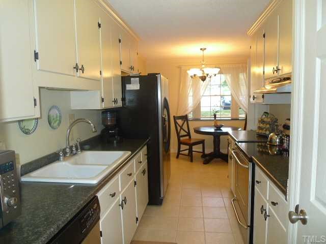2901 Wycliff Road Raleigh, NC 27607 - Photo 4 of 10 a kitchen with sink refrigerator and cabinets