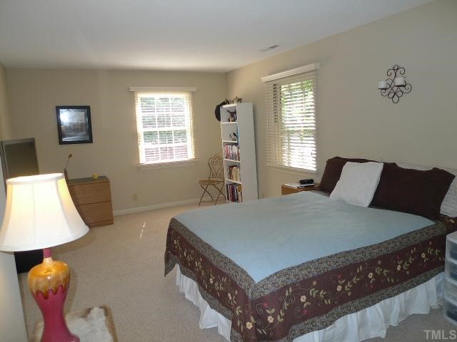 2901 Wycliff Road Raleigh, NC 27607 - Photo 6 of 10 a bed sitting in a bedroom next to a window