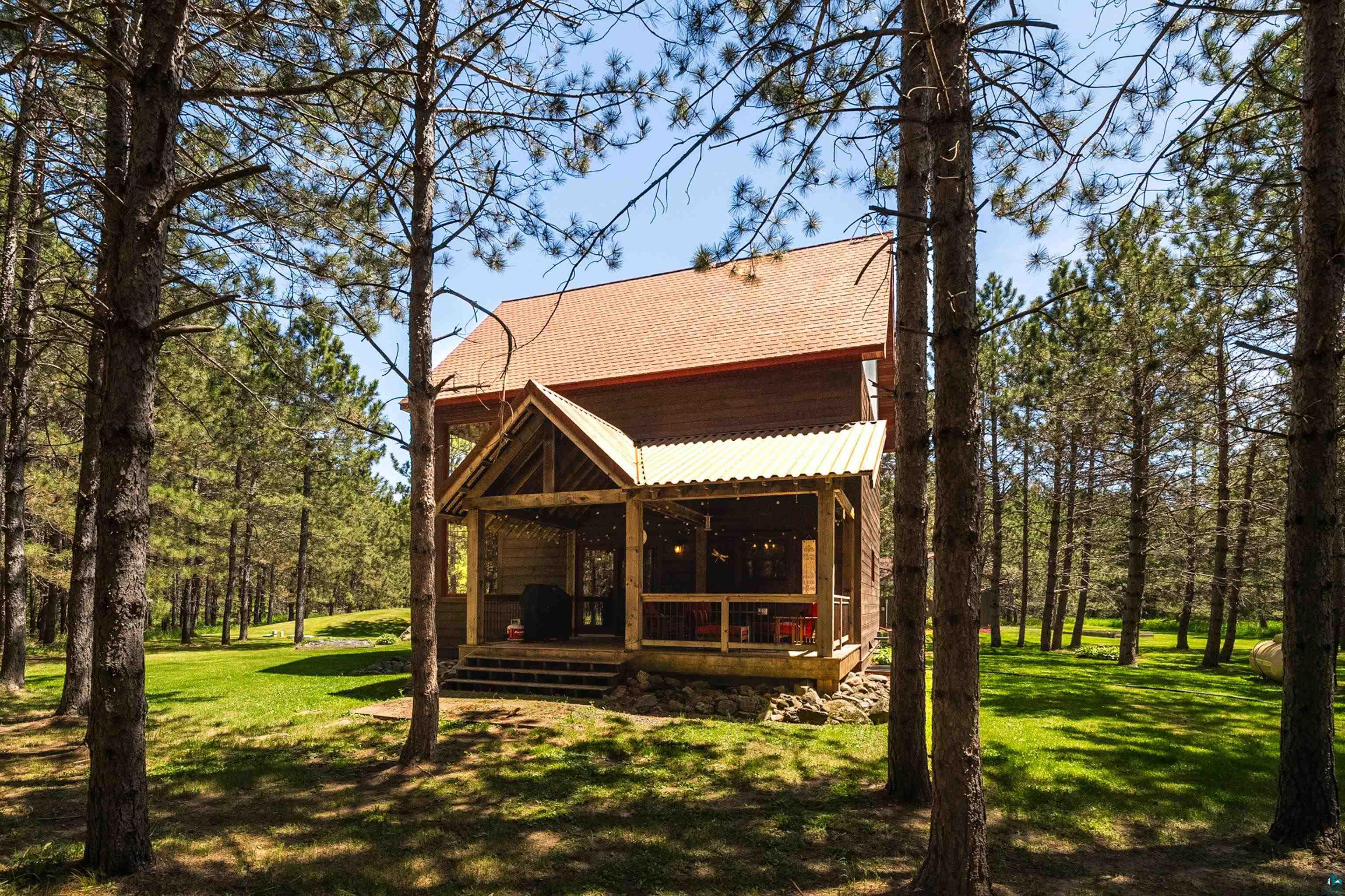 75 East Stark Road Esko, MN 55733 - Photo 62 of 87 Wood-sided residence featuring a gabled roof and a screened-in porch with a corrugated metal roof