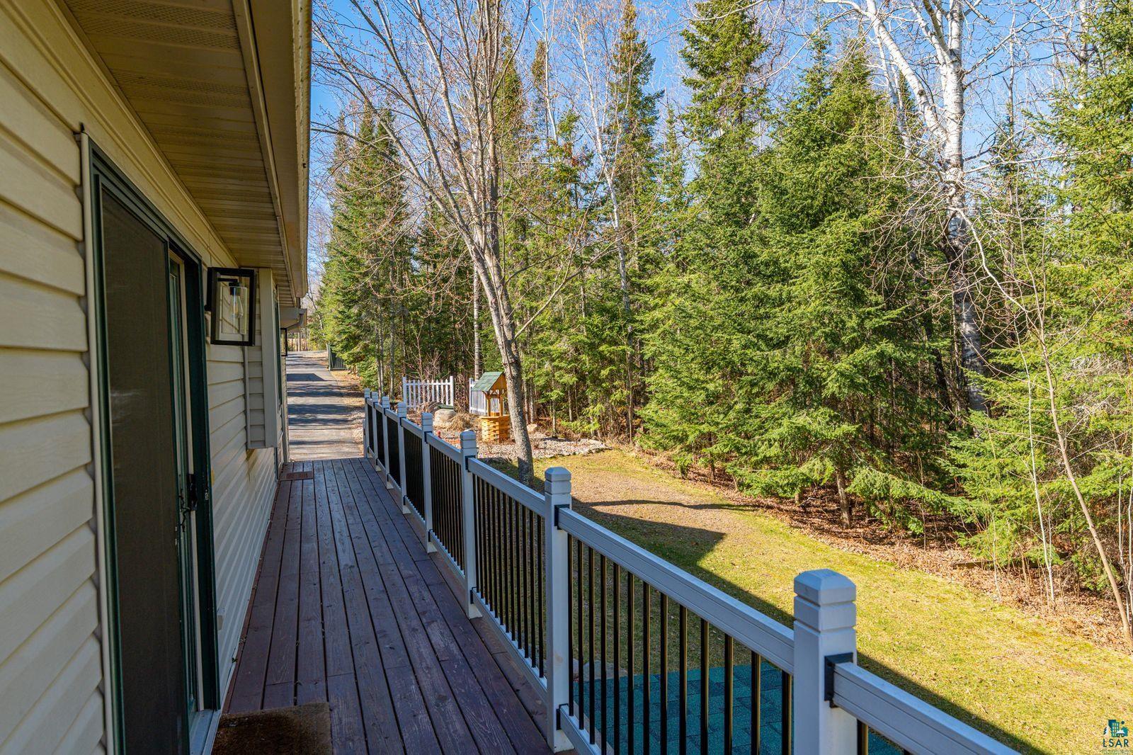4452 Moccasin Point Road Tower, MN 55790 - Photo 31 of 44 Spacious exterior deck with wood-finish flooring and white and black railing