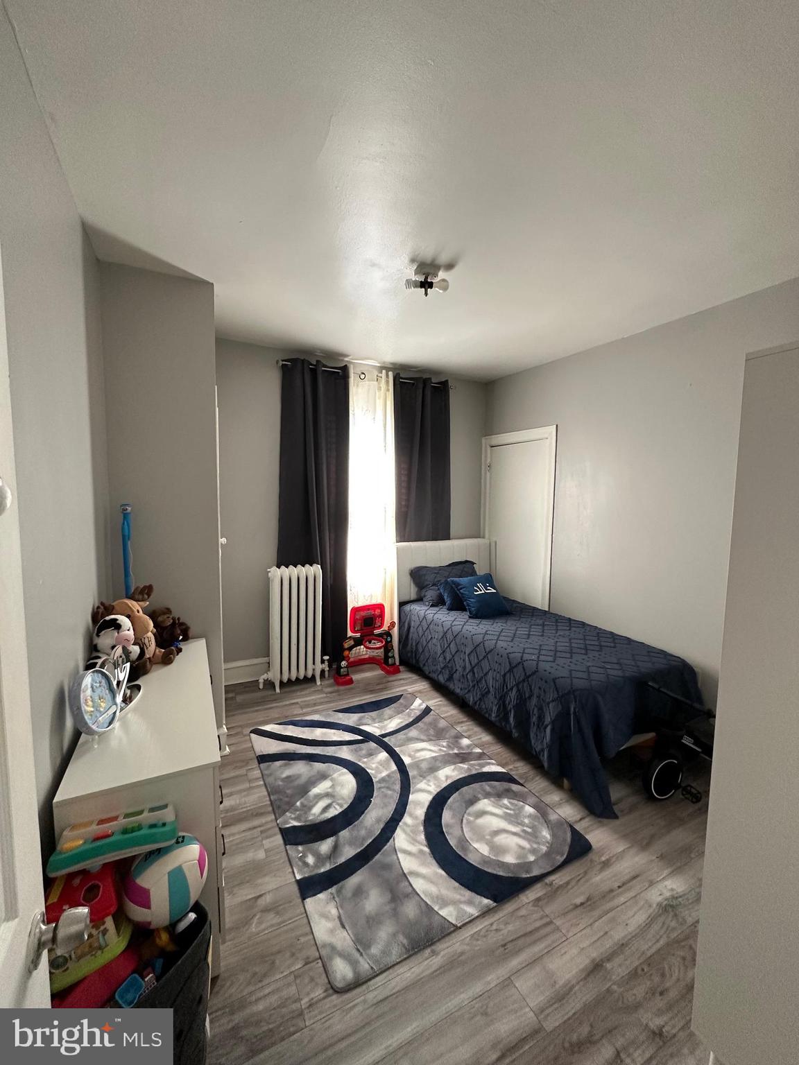 4914 Ormes Street Philadelphia, PA 19120 - Photo 19 of 33 a bedroom with furniture and a wooden floor