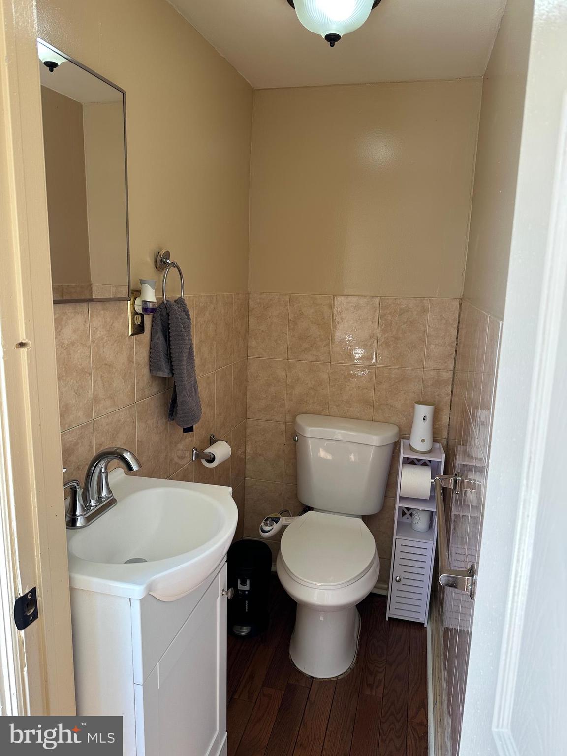 4914 Ormes Street Philadelphia, PA 19120 - Photo 23 of 33 a bathroom with a toilet sink and mirror