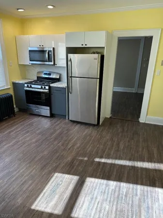 a kitchen with a refrigerator and a stove top oven