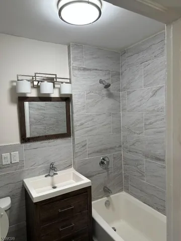 a kitchen with a sink wooden cabinets and a granite counter top