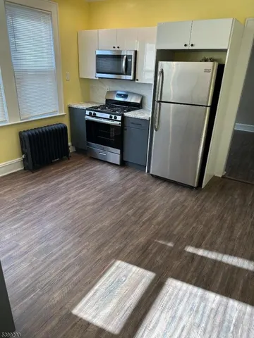 a kitchen with a refrigerator and a sink
