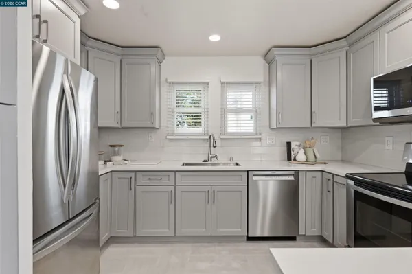 a kitchen with a sink stove and refrigerator