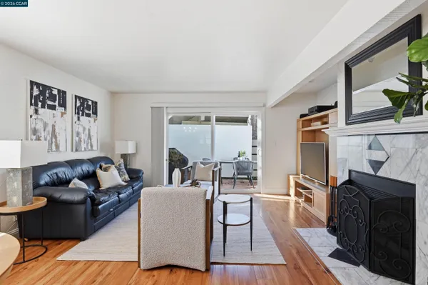 a living room with furniture and a fireplace