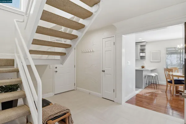 a view of entryway and hall with wooden floor