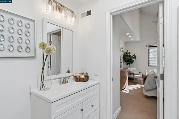 a bedroom with a bed and a lamp