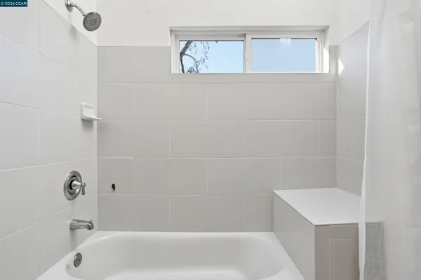 a bed room with a bed and a painting on the wall