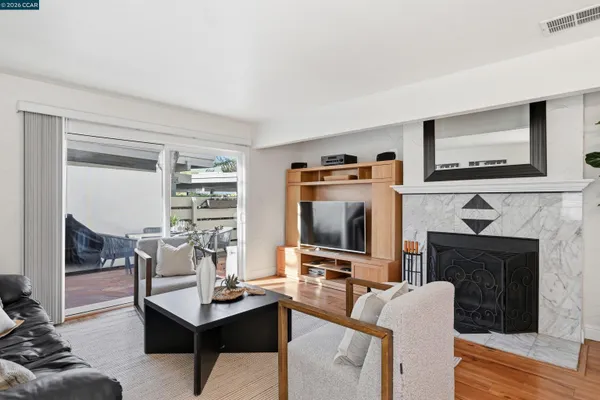 a living room with furniture a fireplace and a flat screen tv