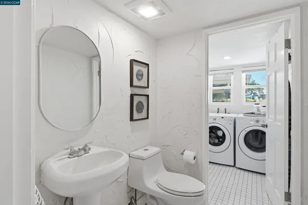 a view of a white house with a yard and potted plants