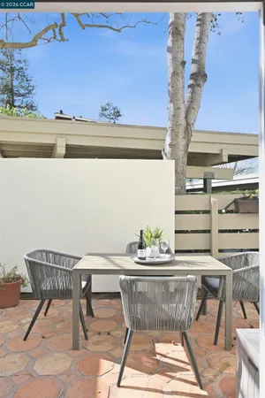 a view of a park with bench plants and large trees