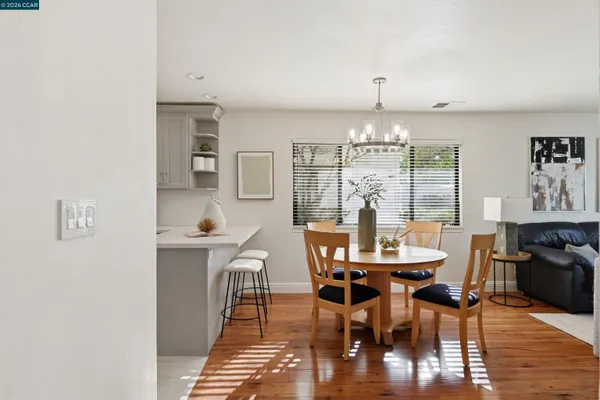 a view of a dining room with furniture window and wooden floor