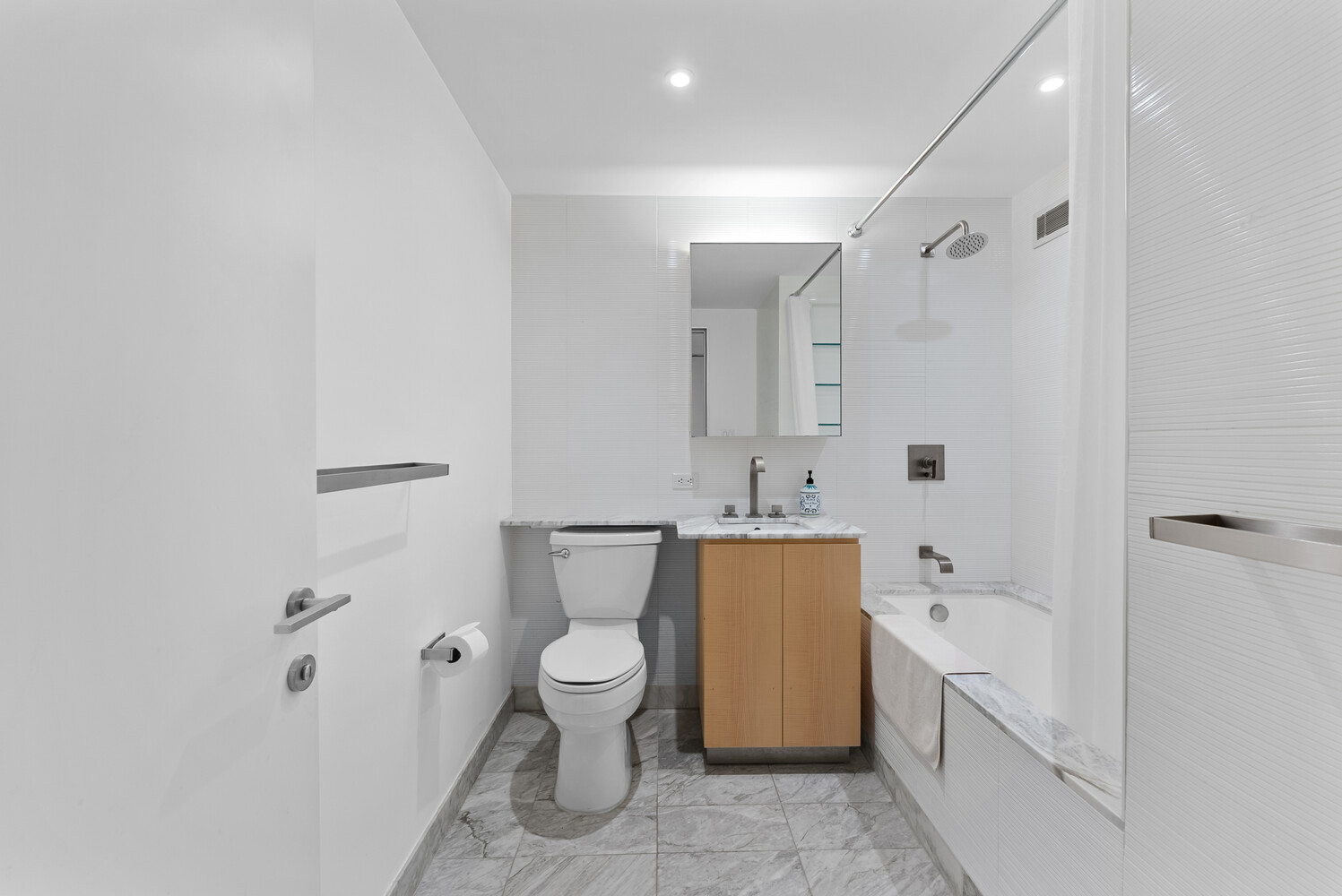 322 West 57th Street, Unit 39K Manhattan, NY 10019 - Photo 11 of 23 a bathroom with a toilet sink and bathtub