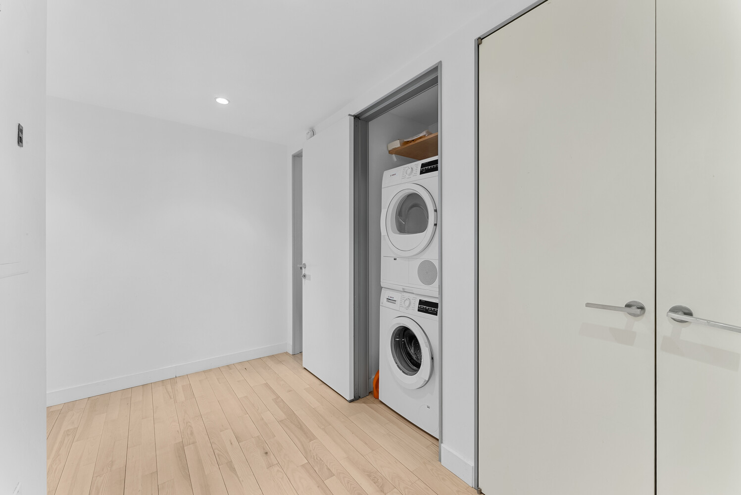 322 West 57th Street, Unit 39K Manhattan, NY 10019 - Photo 13 of 23 a view of a storage & utility room with dryer and washer