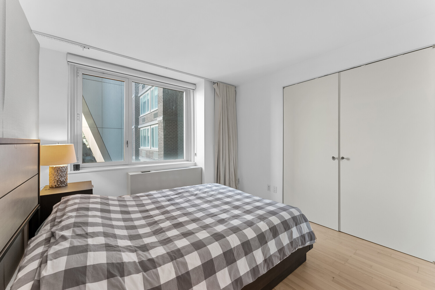 322 West 57th Street, Unit 39K Manhattan, NY 10019 - Photo 14 of 23 a bedroom with a bed and a window