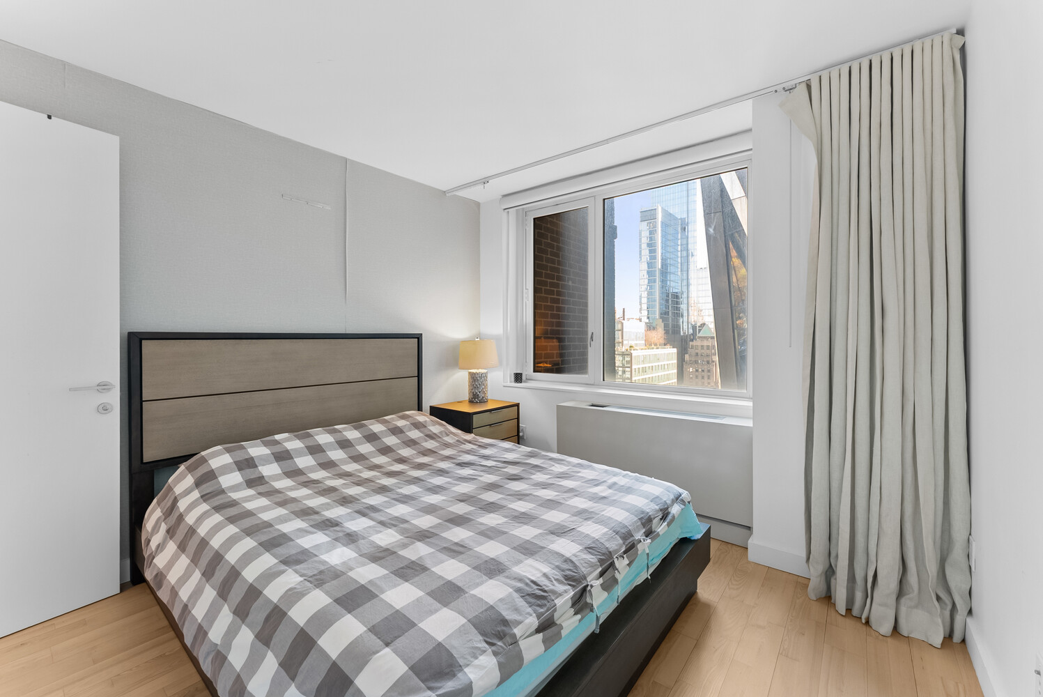 322 West 57th Street, Unit 39K Manhattan, NY 10019 - Photo 15 of 23 a bedroom with a bed and a window