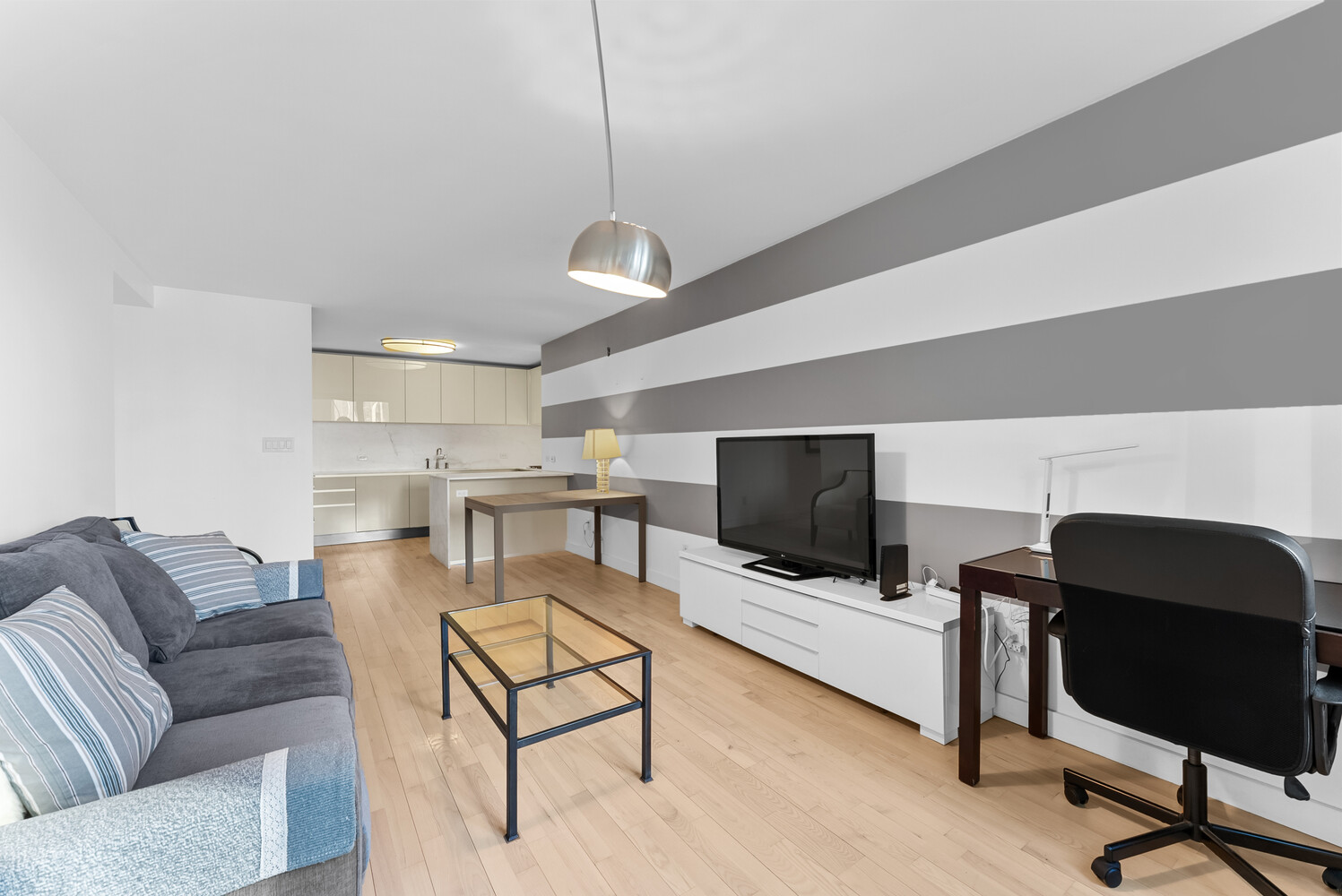 322 West 57th Street, Unit 39K Manhattan, NY 10019 - Photo 18 of 23 a living room with furniture and a flat screen tv