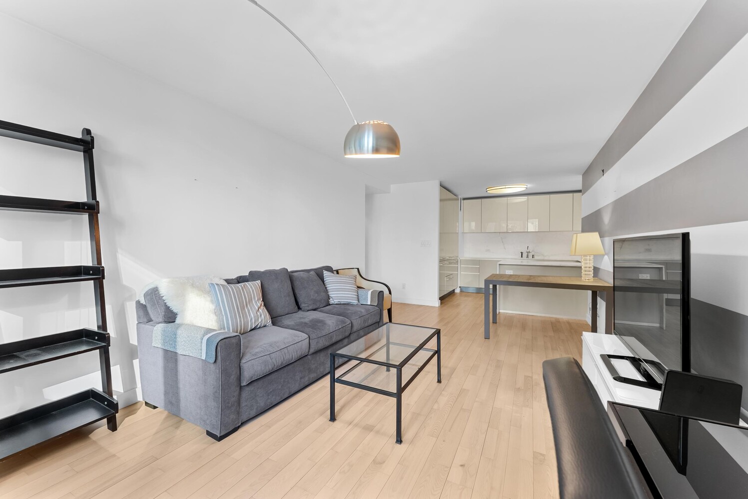 322 West 57th Street, Unit 39K Manhattan, NY 10019 - Photo 20 of 23 a living room with furniture and a wooden floor