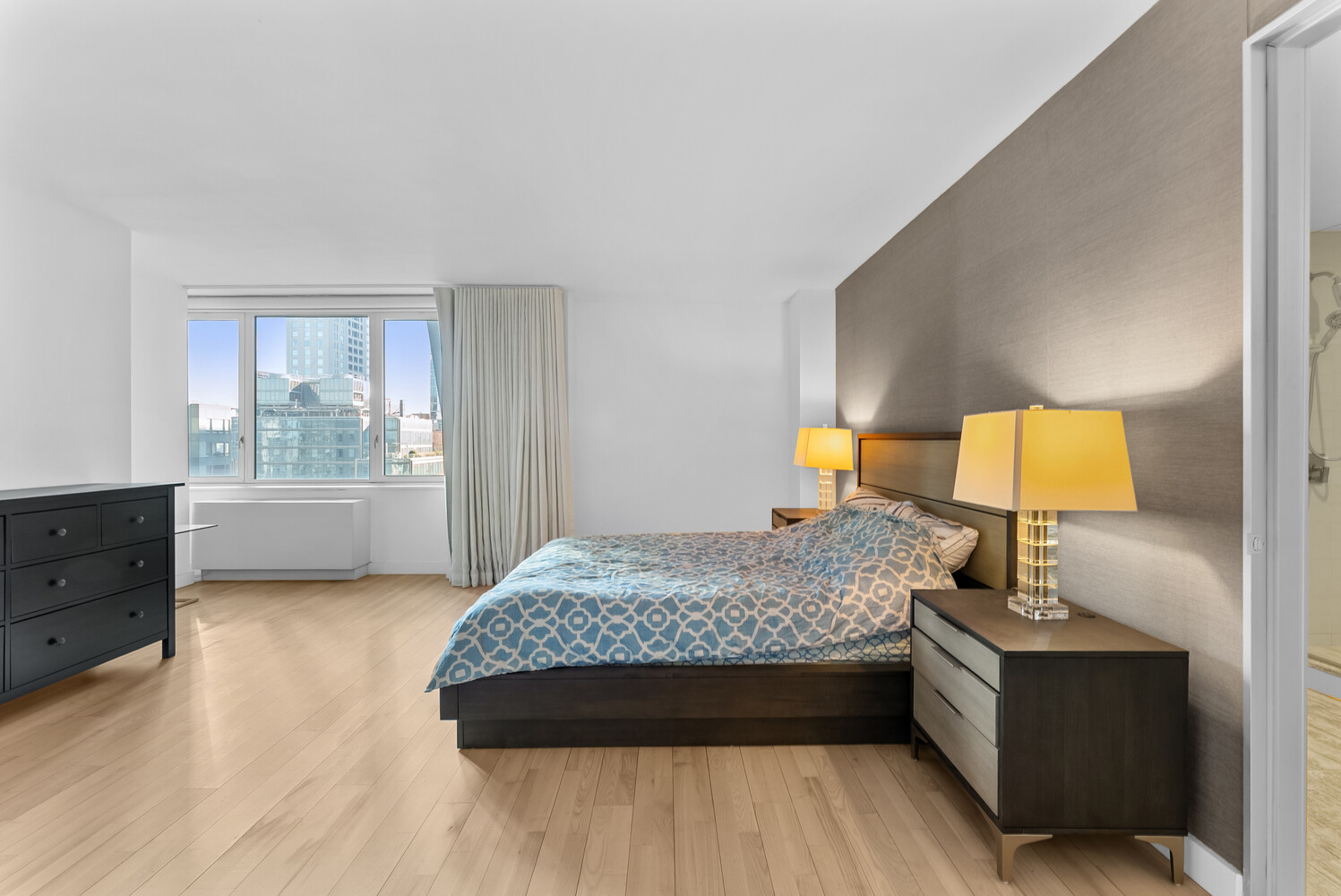 322 West 57th Street, Unit 39K Manhattan, NY 10019 - Photo 6 of 23 a bedroom with a bed and window