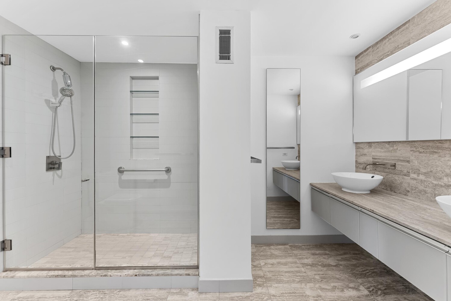 322 West 57th Street, Unit 39K Manhattan, NY 10019 - Photo 8 of 23 a bathroom with a granite countertop sink two mirror and shower