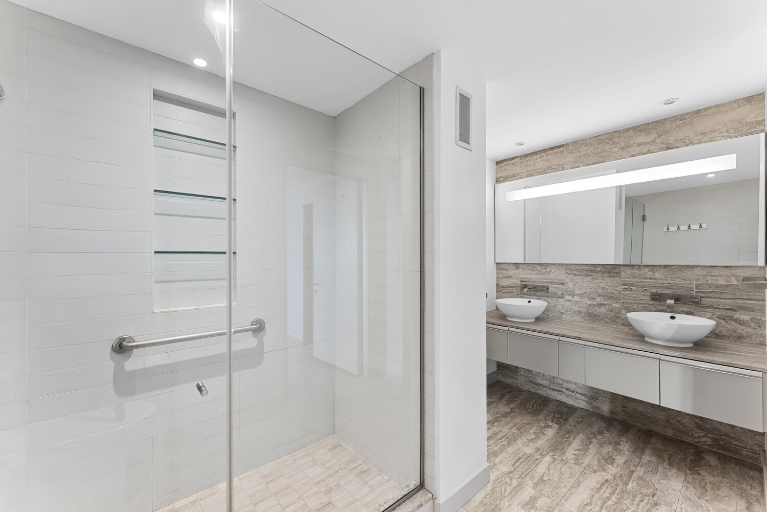 322 West 57th Street, Unit 39K Manhattan, NY 10019 - Photo 9 of 23 a bathroom with a granite countertop sink and a mirror