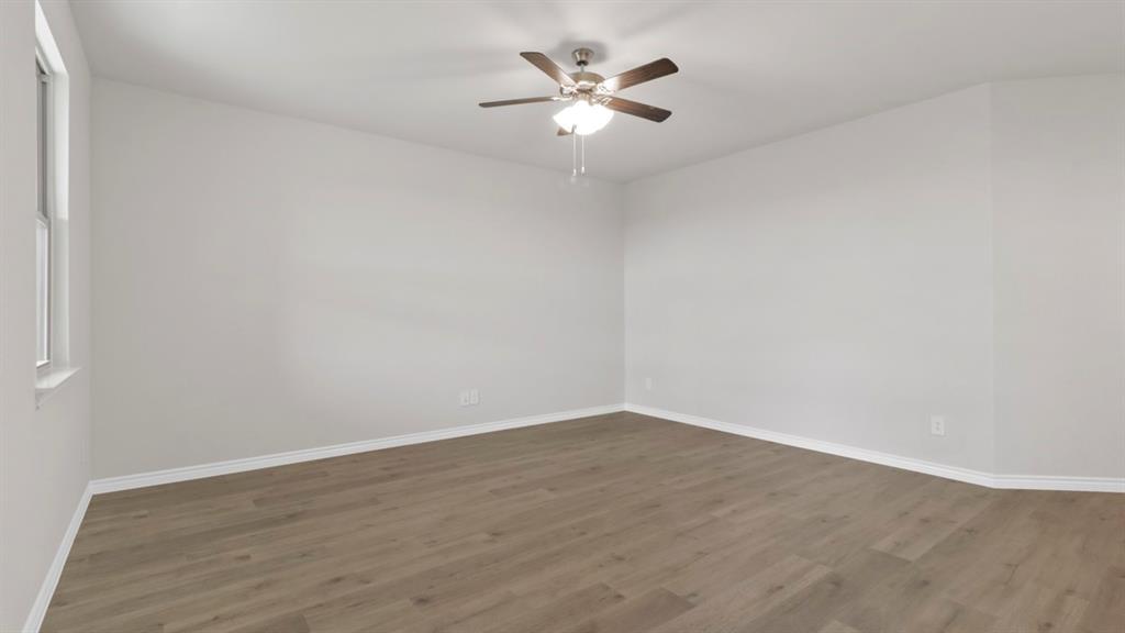 510 Range Road Caddo Mills, TX 75135 - Photo 20 of 25 Empty room with a ceiling fan and dark wood-style floors