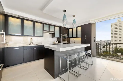 a kitchen with a center island a sink cabinets and stainless steel appliances