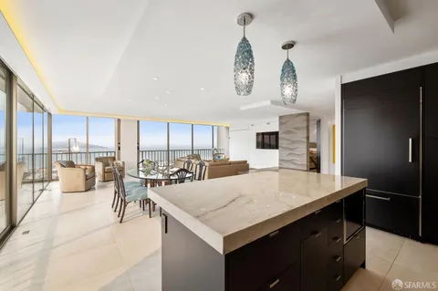 a kitchen with a table chairs and a refrigerator