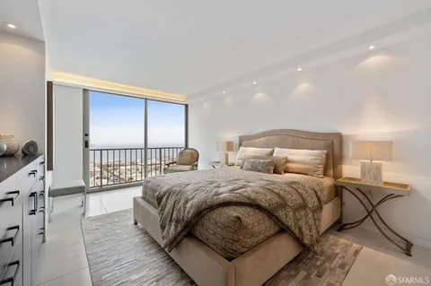 a bedroom with a large bed and a large window