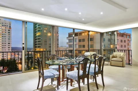 a dining room with furniture and a floor to ceiling window