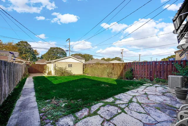 a view of a garden with wooden fence
