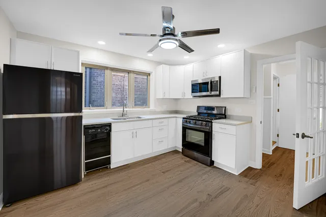 a kitchen with a refrigerator stove and microwave
