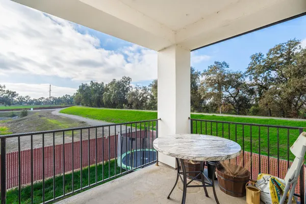 a view of a patio with a table chairs and a backyard